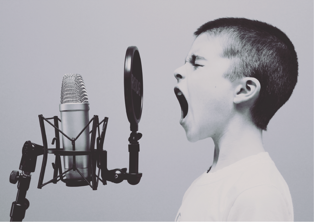 Boy yelling into microphone to promote newsletter